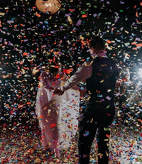 Multicolor confetti cannon burst at wedding celebration