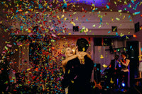 Confetti popper burst with large paper pieces